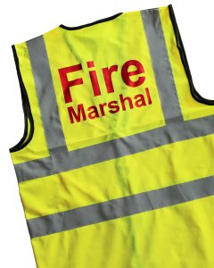 yellow fire marshal vest with red writing
